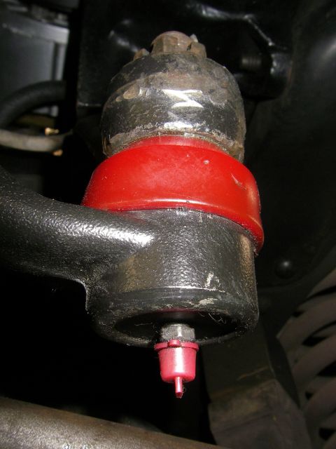 1990 Ford Bronco - This is a close-up view of a ball joint assembly, likely part of a vehicle's suspension system.