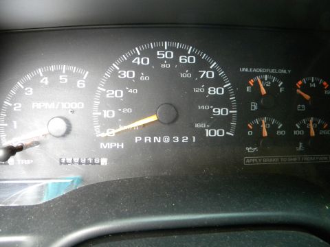 1999 Chevrolet Suburban - The vehicle's interior shows the dashboard gauges, including the speedometer and tachometer.