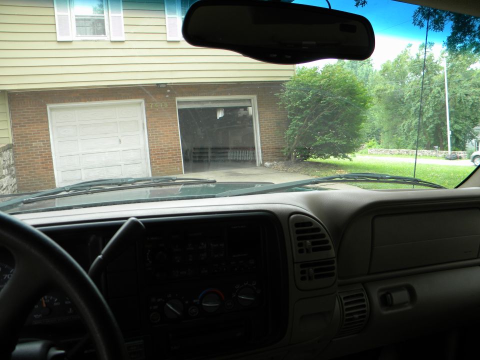 1999 Chevrolet Suburban interior dashboard with windshield view of a garage