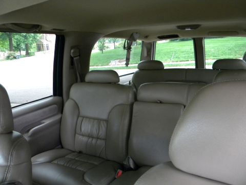 1999 Chevrolet Suburban - Interior view of a 1999 Chevrolet Suburban, highlighting the tan leather seating arrangement.