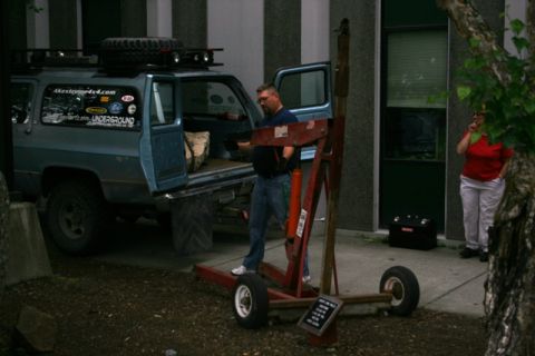 1990 Chevrolet Suburban - Blue Chevrolet K5 Blazer with modifications, including a roof rack and off-road tires, parked outside a building.