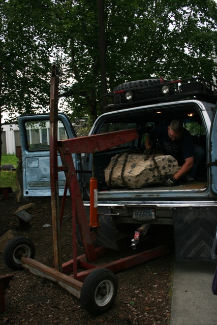 1990 Chevrolet Suburban - Loading a large rock into the bed of a 1990 Chevrolet Suburban using an engine hoist.