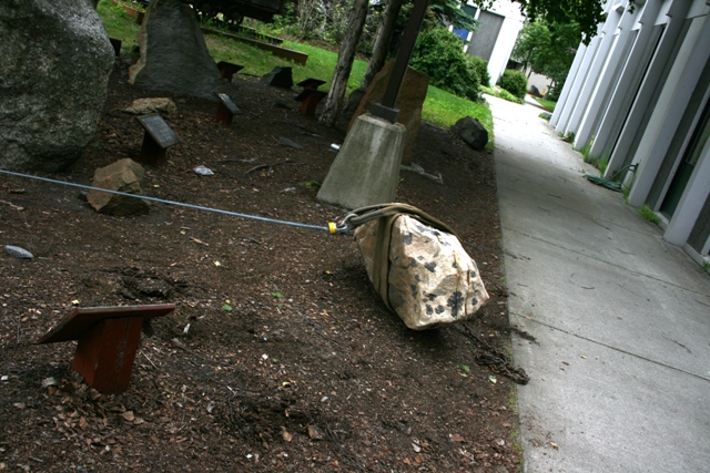 Rock garden with large stones and a cable connecting one stone