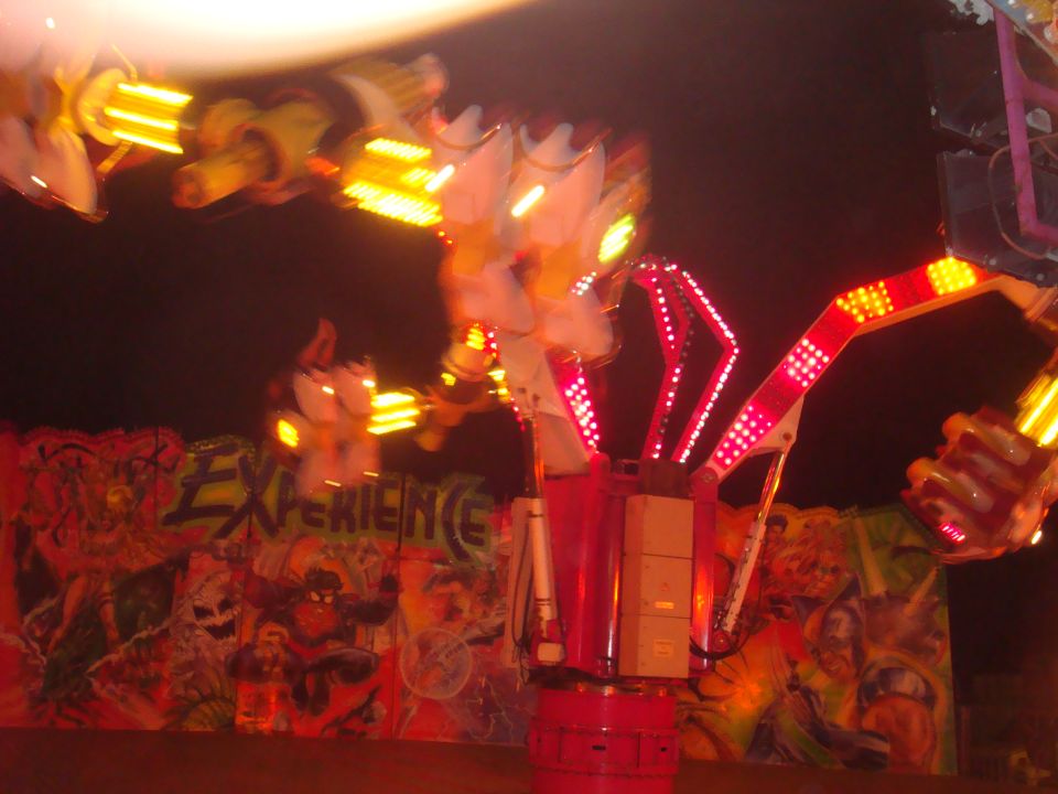 Blurry carnival ride with flashing lights and graffiti art background