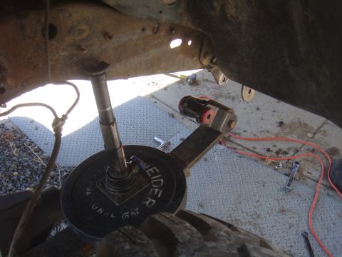 close-up of vehicle suspension with a weight plate on it