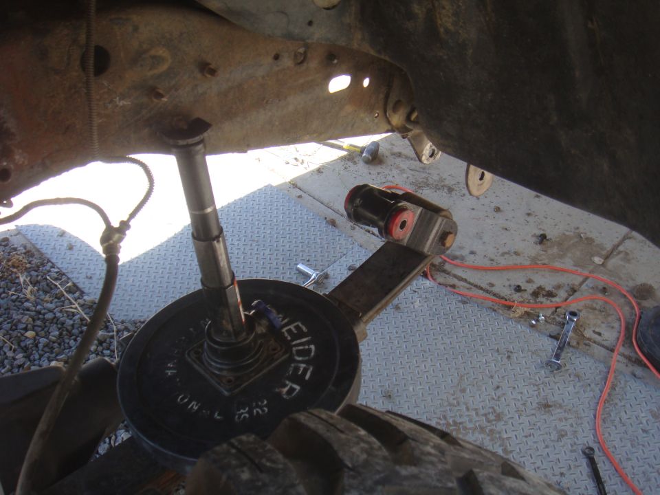 close-up of vehicle suspension with a weight plate on it