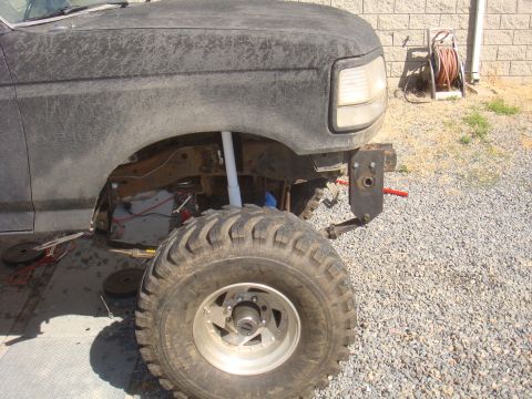 Front fender and tire of a lifted Ford truck, possibly F-150 or Bronco, with aftermarket bumper bracket