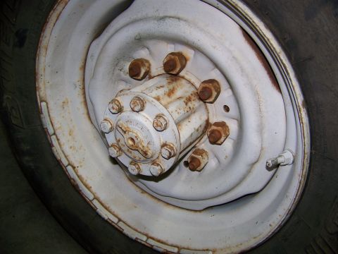 1992 Jeep YJ - A close-up view of a vehicle's wheel hub and tire, showing the lug nuts and valve stem.