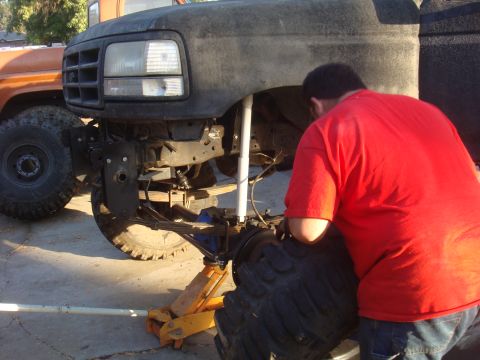 1992 Ford Bronco front end being worked on, another truck in background