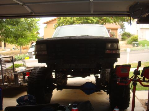 Lifted truck front view, large tires, undercarriage visible