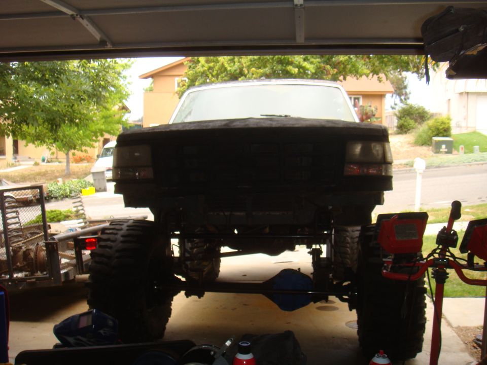 Lifted truck front view, large tires, undercarriage visible
