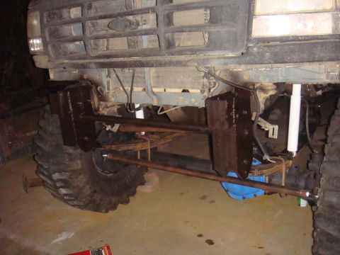 1992 Ford Bronco front axle with large tires, custom steering components, and leaf springs