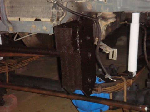 Close-up of vehicle frame with suspension components and a black bracket