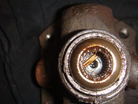 Close-up of a worn universal joint with visible internal splines and a pin