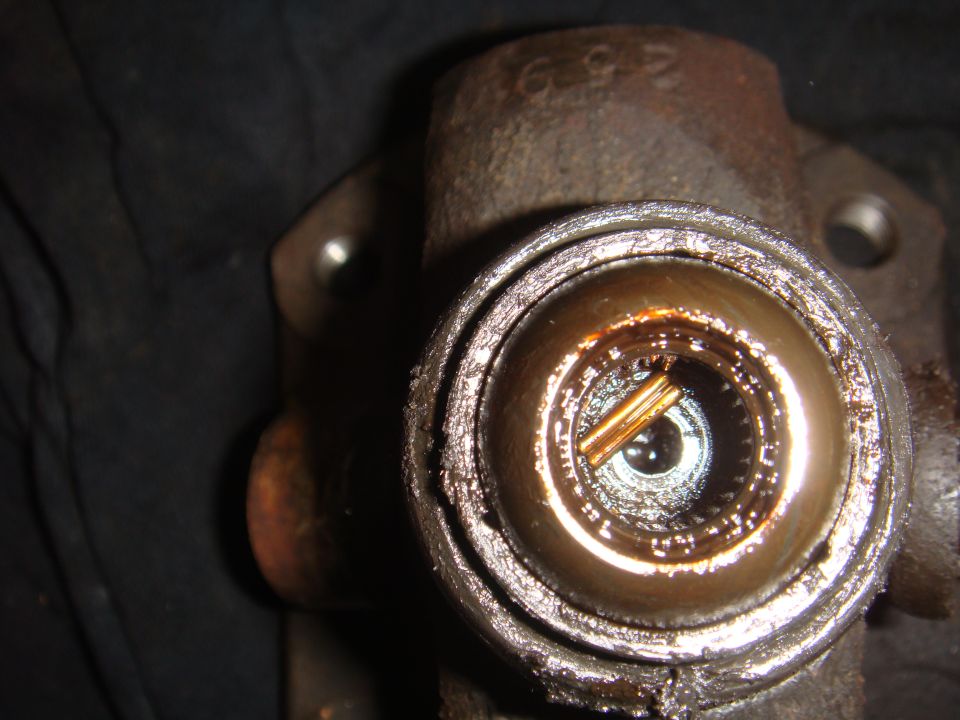Close-up of a worn universal joint with visible internal splines and a pin