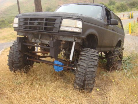 Black 1992 Ford Bronco with lifted suspension and large tires, front view