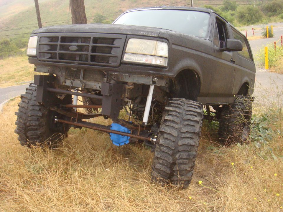 Black 1992 Ford Bronco with lifted suspension and large tires, front view