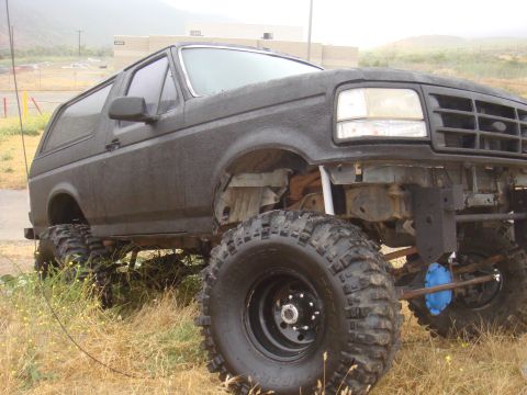 Black 1992 Ford Bronco with lifted suspension and off-road tires