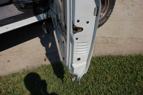 1994 Ford Bronco - Interior view of a car door, revealing the latch mechanism and internal components.