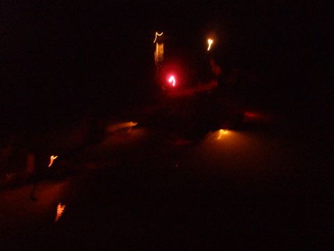1998 Chevrolet Silverado 1500 - A blurry nighttime scene shows a red traffic light and distant orange lights.