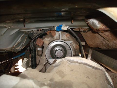 1996 Ford Bronco - Underside view of a vehicle's transfer case, showing mechanical and electrical components.