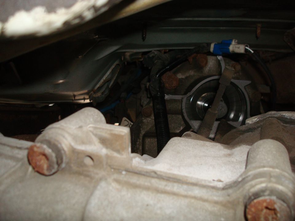 Close-up of vehicle transmission and drivetrain parts, with Supermotors.net logo visible