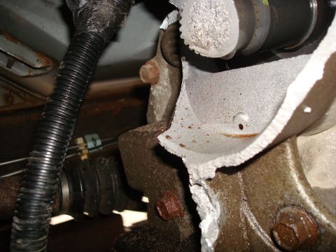 1996 Ford Bronco - This image shows a damaged mechanical part of a vehicle, possibly from an impact or wear.