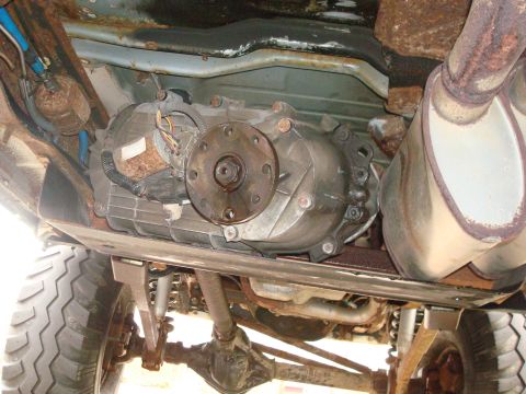 1996 Ford Bronco - Undercarriage view of a vehicle's transmission, transfer case, and exhaust system, with visible rust.