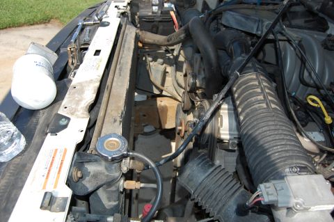 1994 Ford Bronco - Radiator fan and shroud removed for better access. First hole started.