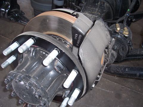 1996 Ford Bronco - This image shows a detailed view of a heavy-duty truck's brake caliper and rotor, highlighting the mechanical components involved in brakin…
