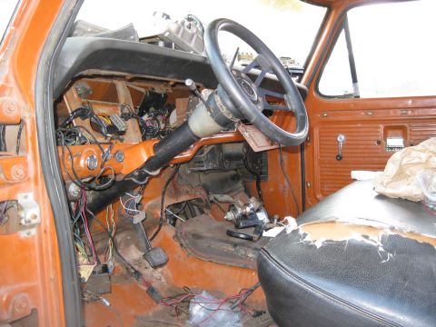 1969 Ford F-250 - The interior of a truck shows exposed wiring and a damaged seat, suggesting ongoing repairs or a project vehicle.