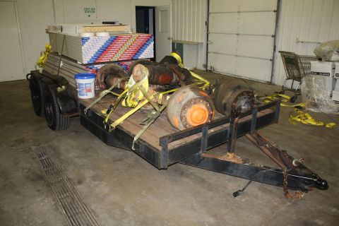 1985 Ford F-350 - Trailer carrying heavy parts and construction materials inside a garage or warehouse.