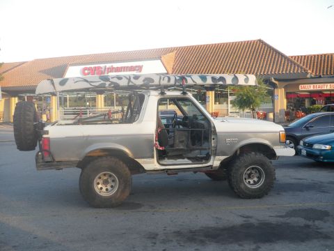 1991 Ford Bronco - This modified Ford Bronco is parked in front of a CVS/pharmacy and Sally Beauty Supply store.
