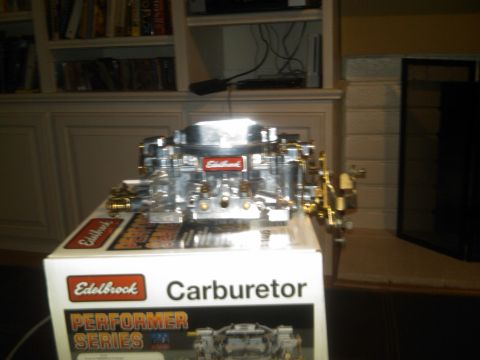 1986 Ford Bronco - A shiny Edelbrock carburetor sits atop its product box, ready for installation.