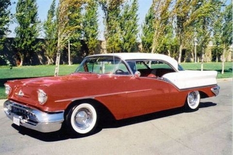 1991 Ford Crown Victoria - This classic two-tone sedan features prominent tail fins and whitewall tires.