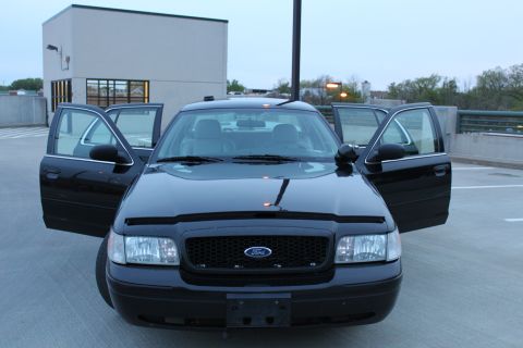 2007 Ford Crown Victoria - Front view of a black 2007 Ford Crown Victoria with all doors open.