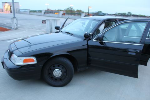 2007 Ford Crown Victoria - Black 2007 Ford Crown Victoria with all doors open, parked on a concrete surface.