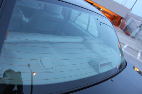 2007 Ford Crown Victoria - Rear view of a car's window, showing interior reflections and defroster lines.