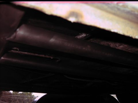1992 Ford Mustang - Underside view of a vehicle's exhaust pipe, showing stamped part numbers.