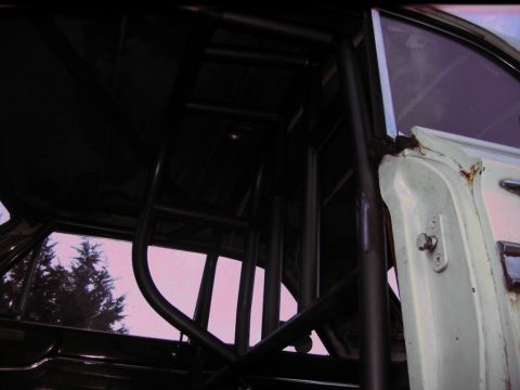 1992 Ford Mustang - Custom roll cage installed inside a vehicle's interior, showing the door frame.