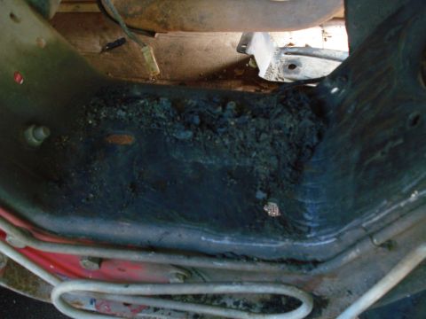 1993 Ford Bronco - Severe rust and damage visible on a vehicle's frame section.