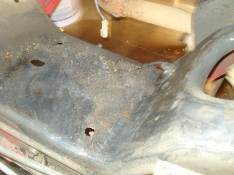 1993 Ford Bronco - Close-up of a heavily rusted frame section, indicating significant wear and potential structural compromise.