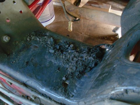 1993 Ford Bronco - This image shows a heavily corroded metal frame part, likely from a vehicle undergoing restoration.