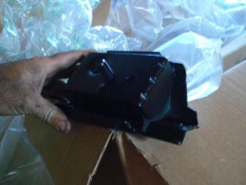 1993 Ford Bronco - A black metal engine mount part is shown, likely for an engine rebuild project.