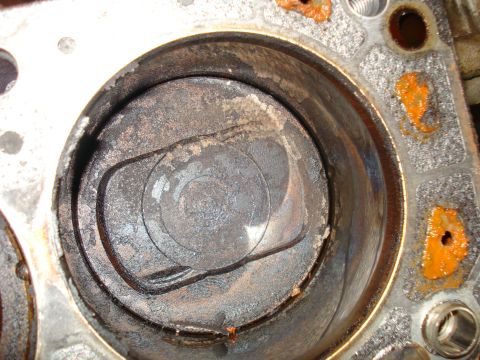 1993 Ford Bronco - Engine cylinder and piston showing significant wear and carbon deposits, indicating a need for rebuild.