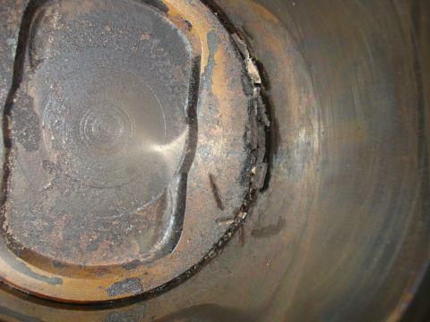 1993 Ford Bronco - A piston shows significant damage and wear, indicating internal engine problems.