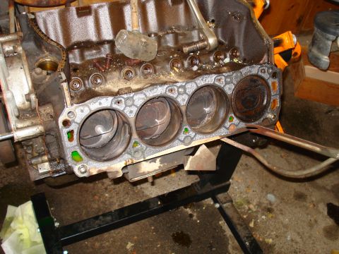 1993 Ford Bronco - Close-up of an engine block, showing the cylinders and pistons after gasket removal.