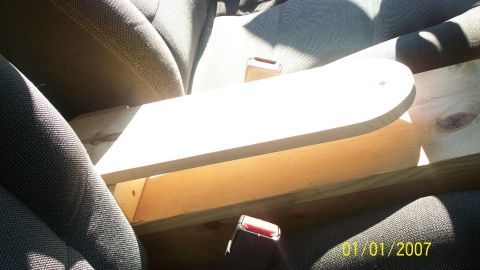 2004 Ford Crown Victoria - A wooden structure is placed on the car's seats, with seatbelts visible.