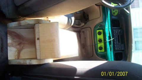 2004 Ford Crown Victoria - Custom wooden insert in vehicle's center console, with green dashboard accents visible.