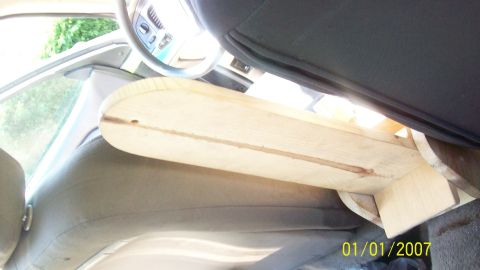 2004 Ford Crown Victoria - A wooden structure has been installed inside the vehicle's cabin, partially covering the seats and dashboard area.